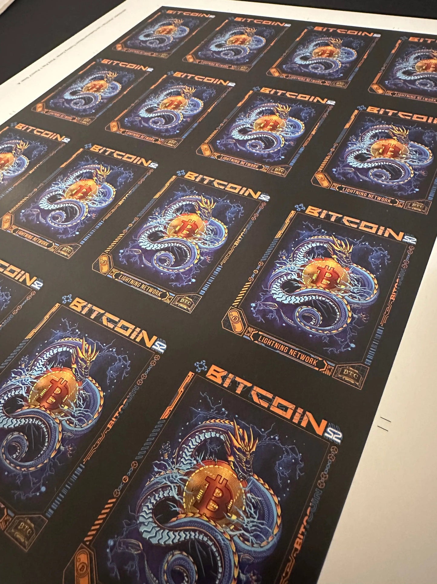 Closer angled perspective view of the uncut production press sheet for Bitcoin Trading Cards featuring the 'Lightning Network' blue dragon artwork.