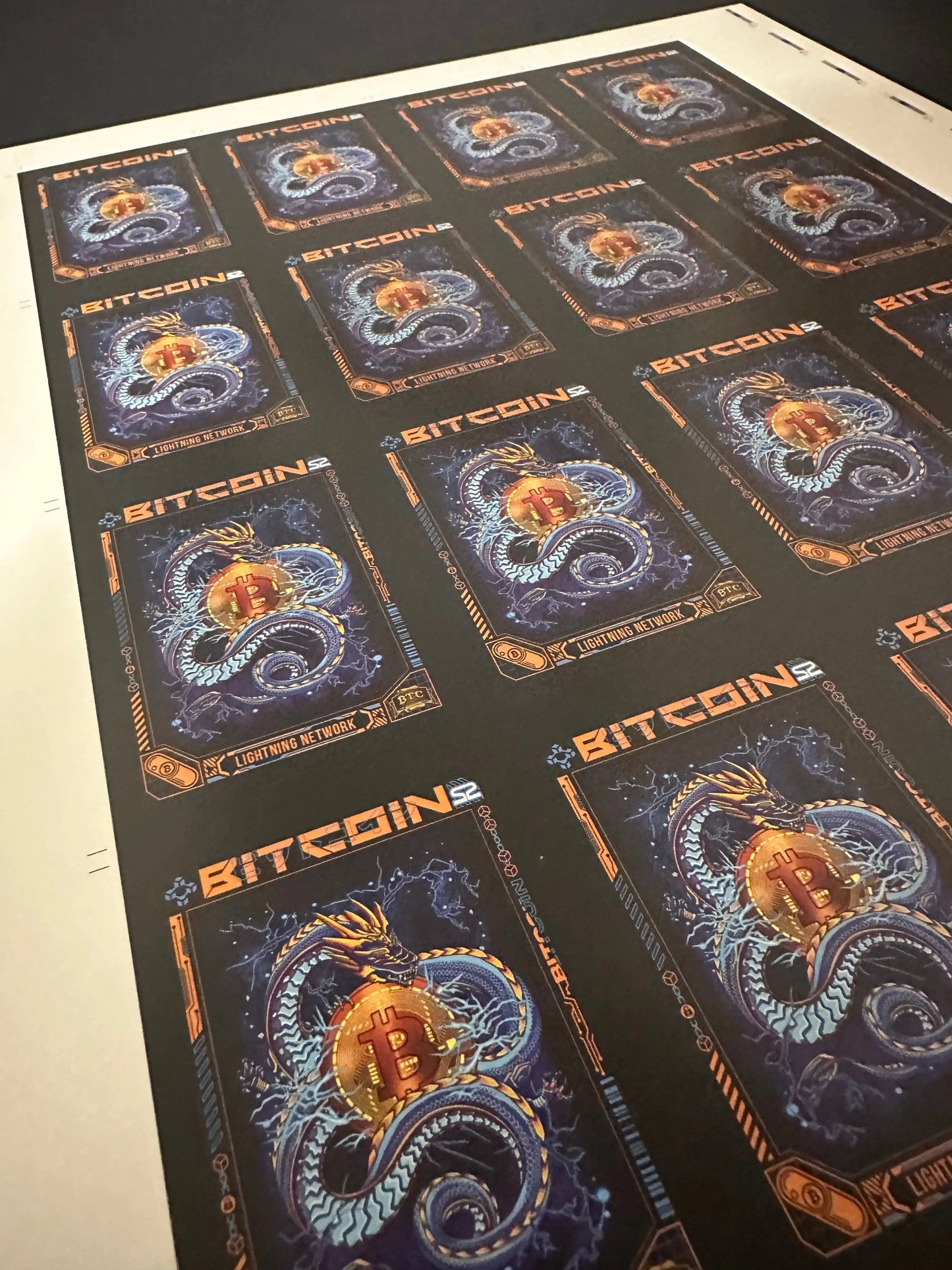 Angled view of an uncut production press sheet for Bitcoin Trading Cards showing the grid of 'Lightning Network' blue dragon cards with printer marks.
