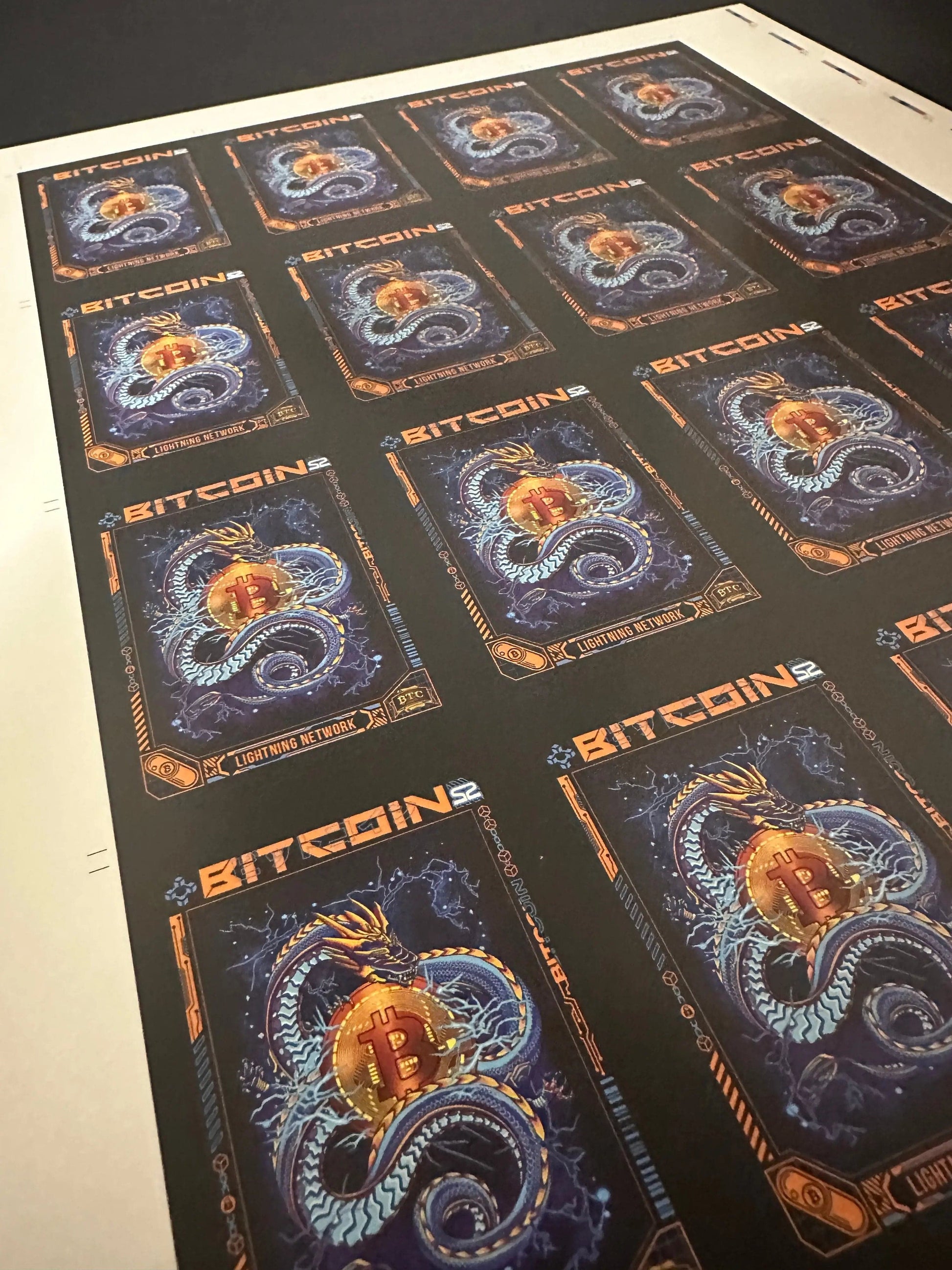 Angled view of an uncut production press sheet for Bitcoin Trading Cards showing the grid of 'Lightning Network' blue dragon cards with printer marks.
