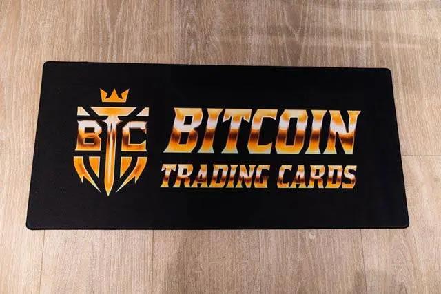 XL BTCTC Logo Breaker Mat featuring golden Based Trading Cards logo on smooth dark surface