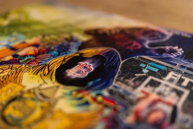 Macro close-up photograph of the physical Series 2 breaker mat, highlighting the fabric texture and print quality of the 'Bitcoin' hooded figure and 'FUD' bear artwork