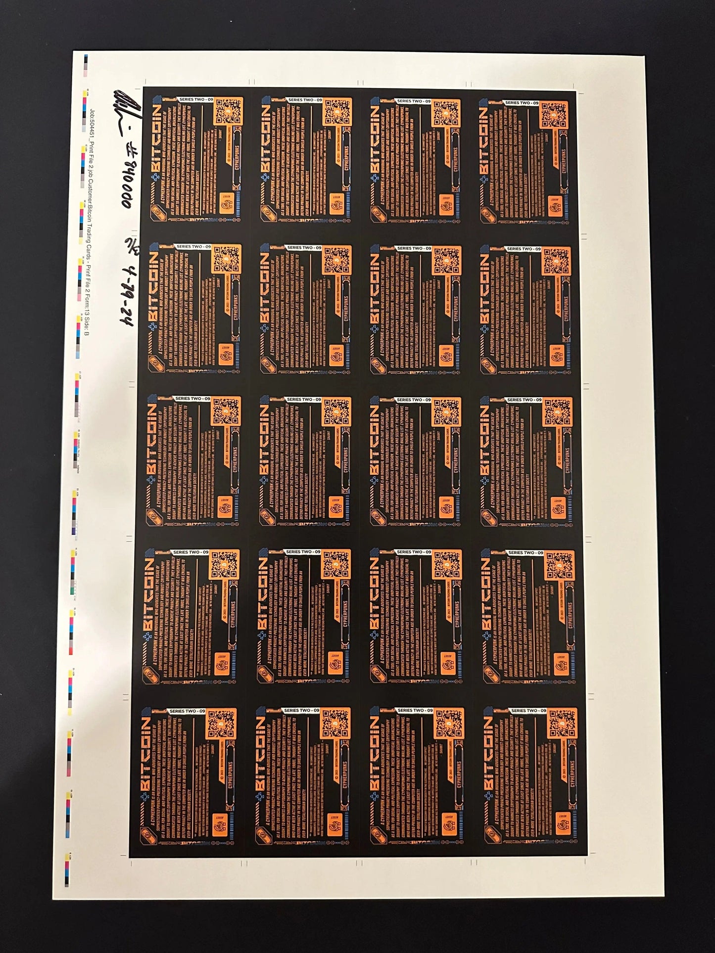 Back of an uncut production press sheet for Bitcoin Trading Cards displaying the text side of 'Cypherpunks' cards with printer color bars and handwritten approval signatures.