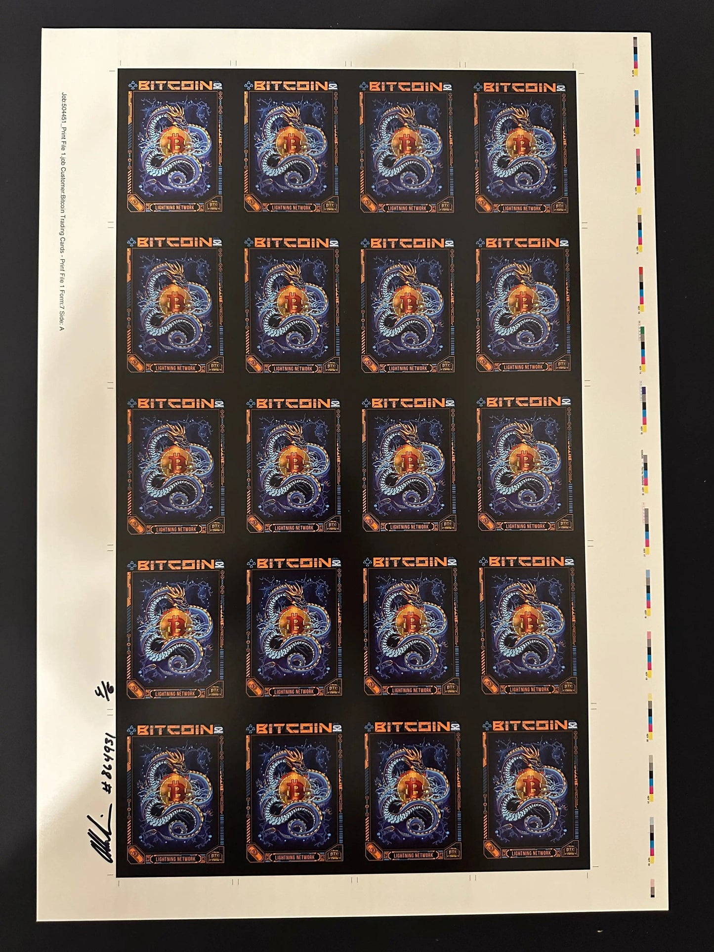Uncut production press sheet for Bitcoin Trading Cards featuring the 'Lightning Network' blue dragon artwork, including handwritten approval signatures and production notes in the margin.
